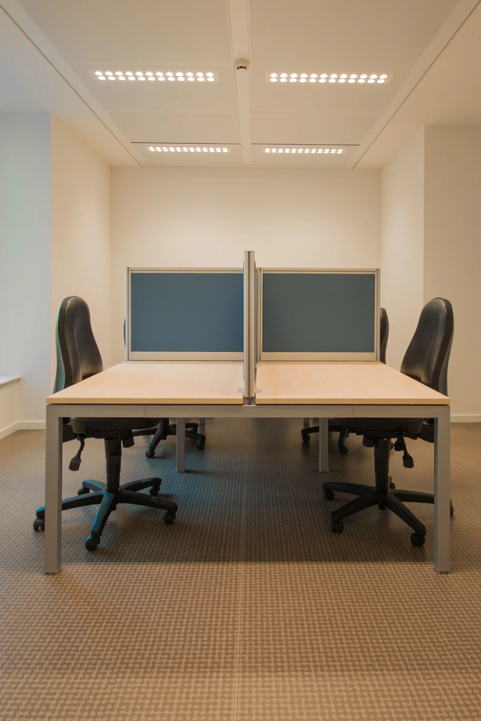 A tidy office with clear desks and freshly cleaned carpet
