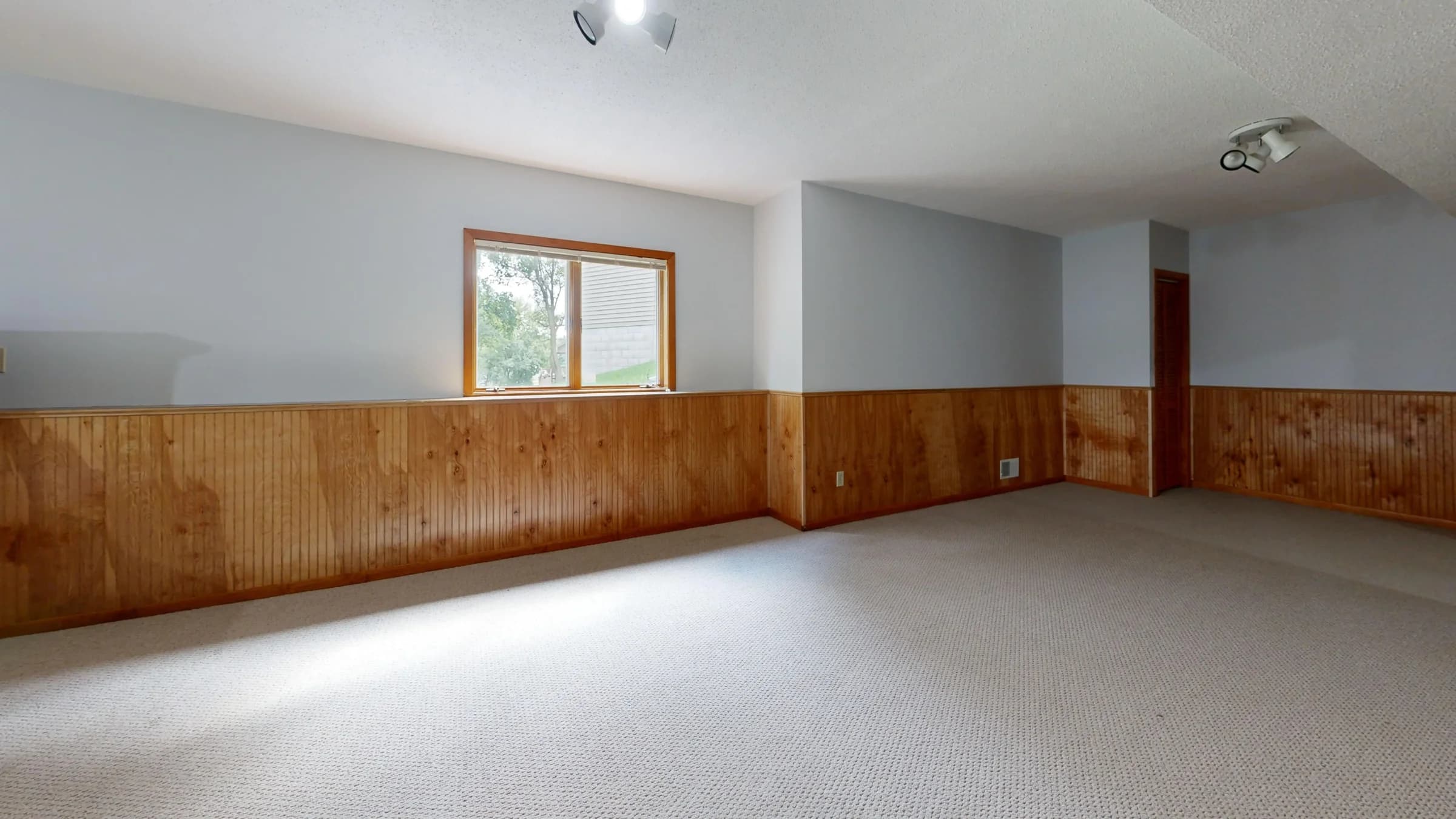 A bright home living room with freshly cleaned carpet and wood panelling