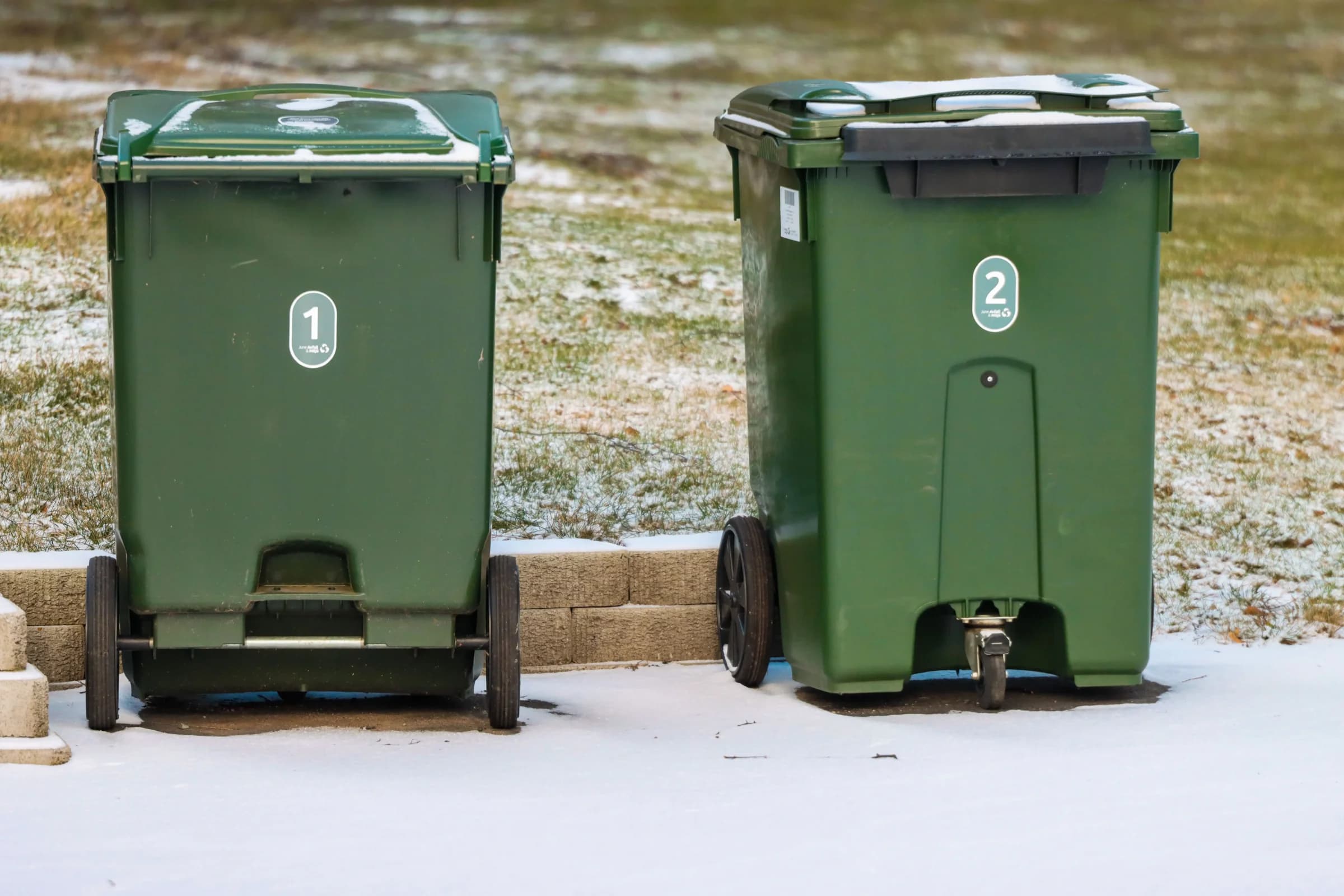 Wheelie bins set out at the kerb for licensed waste collection